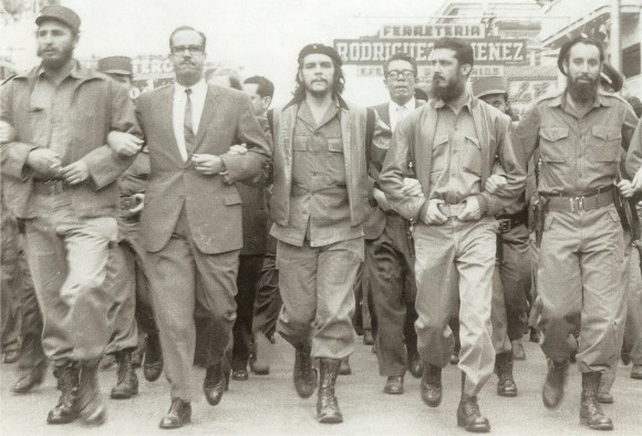 Castro (far left) marching with Che Guevara (center). Photo via Museo Che Guevara, public domain/CC0.