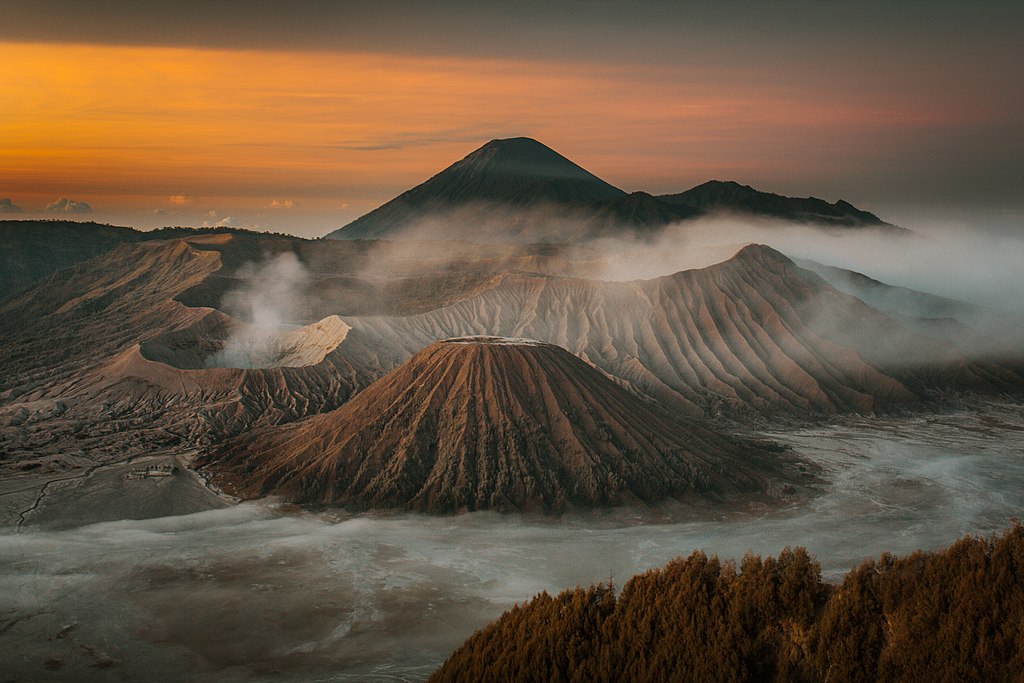 The sunset sneaks past Mount Bromo in Indonesia.